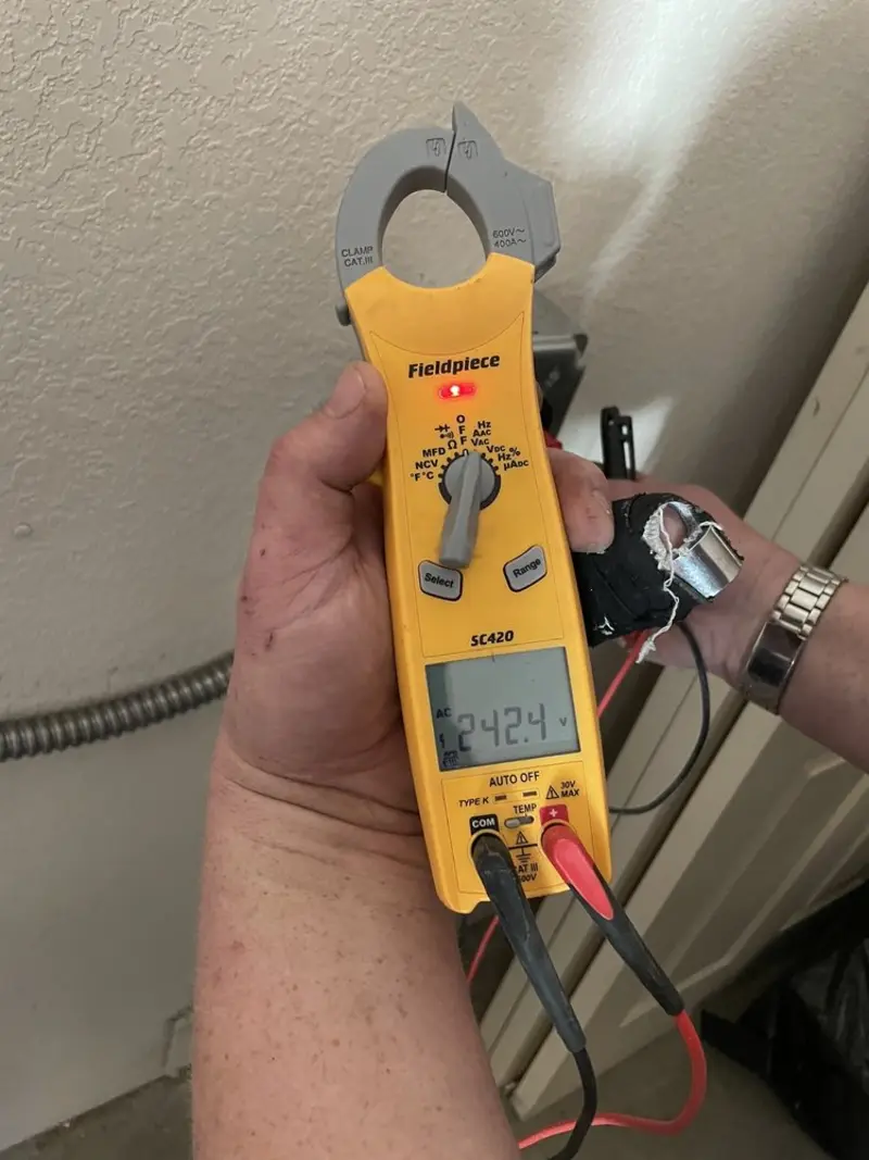 Voltage testing with clamp meter during Outlet Installation in Manlius